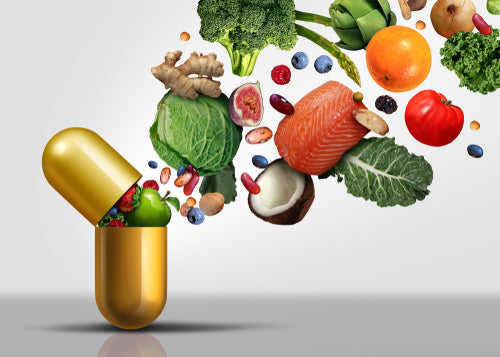 Vitamin capsule with fruits and veggies flying out
